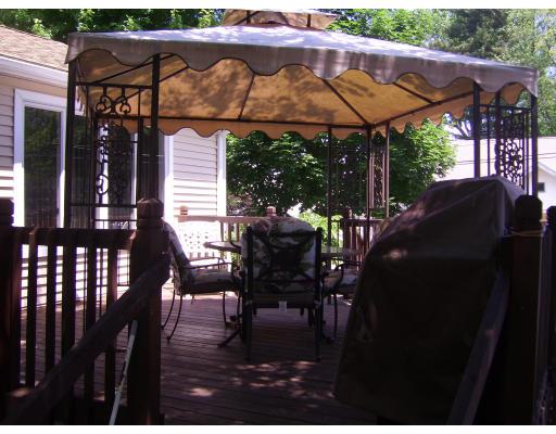 72 Gilbert Avenue Springfield, MA 01119 - Photo 14 of 16 a view of a patio with table and chairs under an umbrella with a small yard