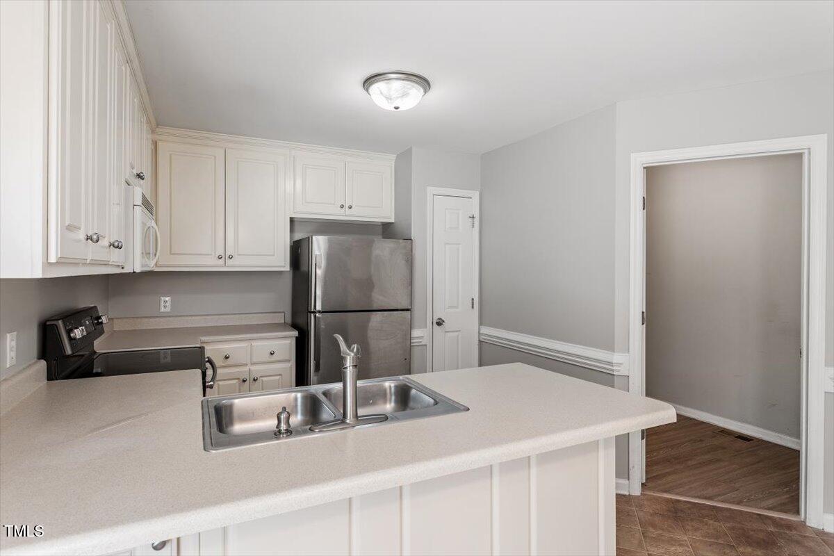 212 Webfoot Drive Garner, NC 27529 - Photo 11 of 26 a kitchen with stainless steel appliances granite countertop a refrigerator and a sink