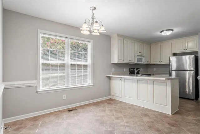 a kitchen with a refrigerator oven and a window