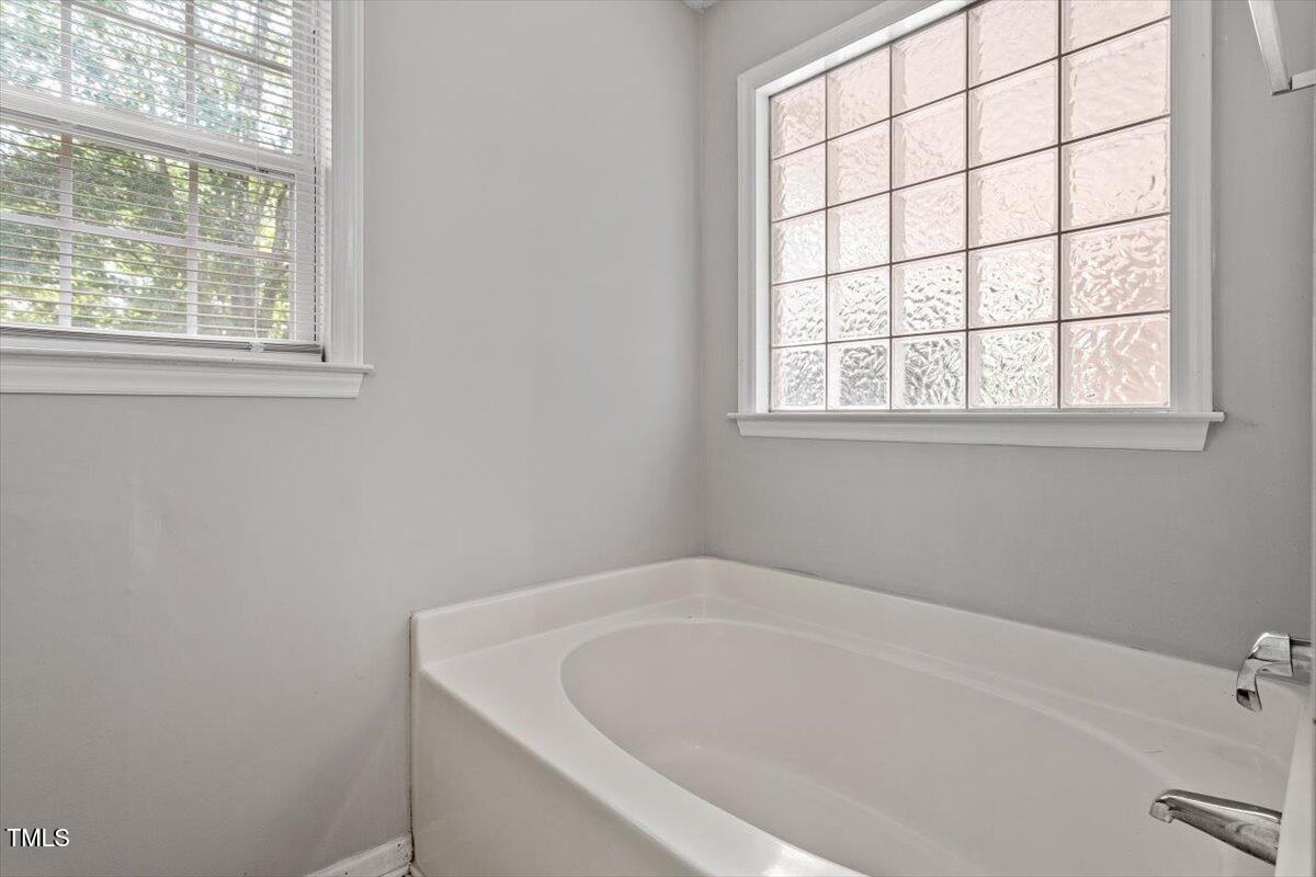 212 Webfoot Drive Garner, NC 27529 - Photo 18 of 26 a white bath tub sitting next to a window
