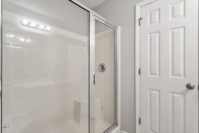 a bathroom with a glass shower door