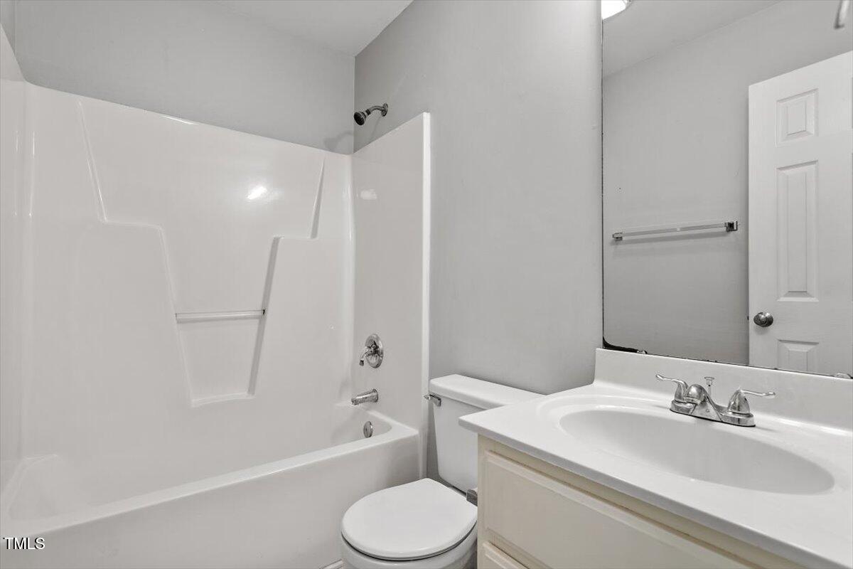 212 Webfoot Drive Garner, NC 27529 - Photo 22 of 26 a bathroom with a toilet a sink and a bathtub
