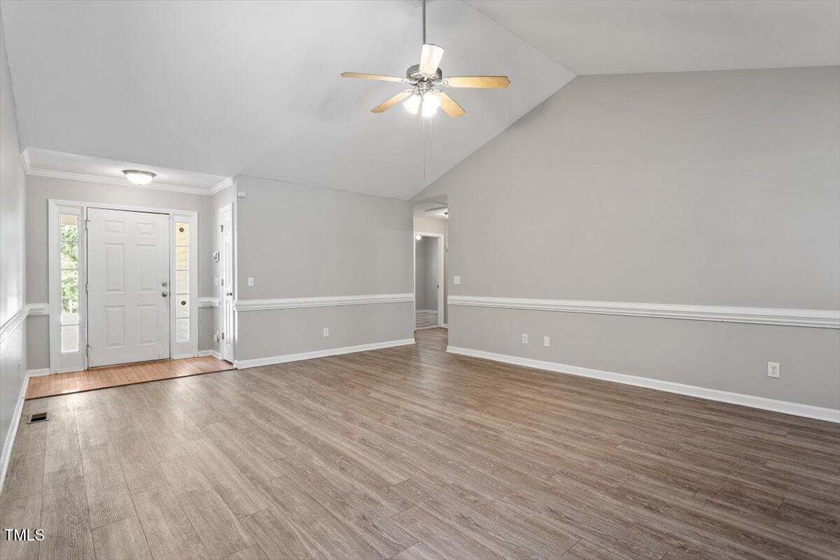 212 Webfoot Drive Garner, NC 27529 - Photo 4 of 26 a view of an empty room with wooden floor