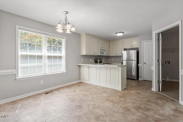 a view of a kitchen with a sink and dishwasher cabinet
