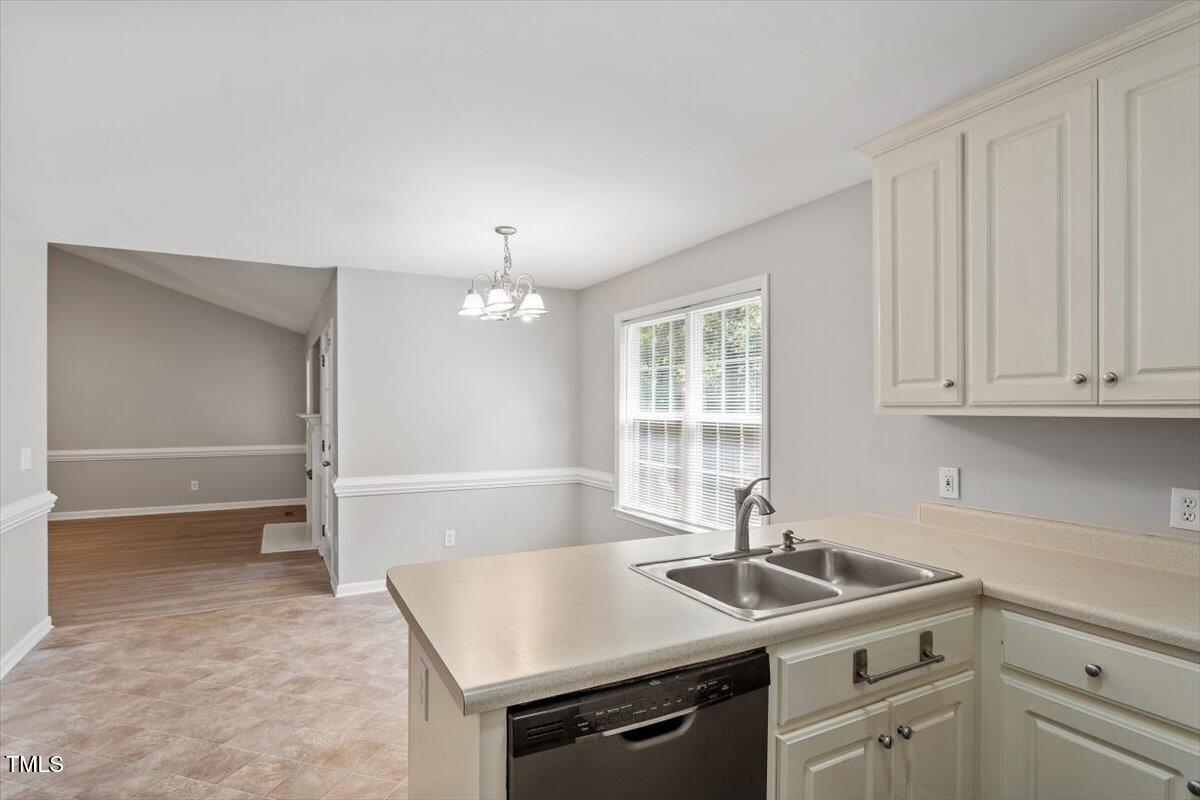 212 Webfoot Drive Garner, NC 27529 - Photo 8 of 26 a kitchen with a sink and cabinets