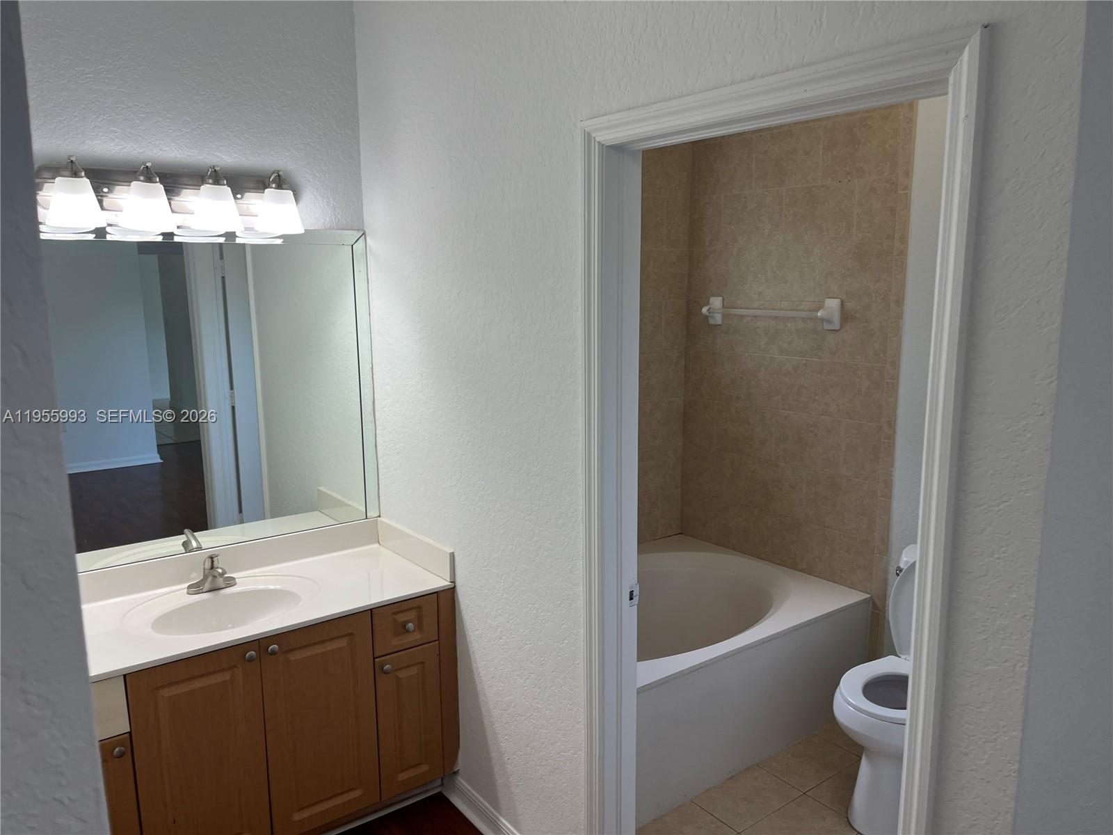 12997 Southwest 219th Terrace, Unit 12997 Miami, FL 33170 - Photo 15 of 24 a bathroom with a sink a toilet and shower