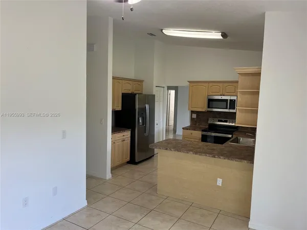 a kitchen with a refrigerator and a stove