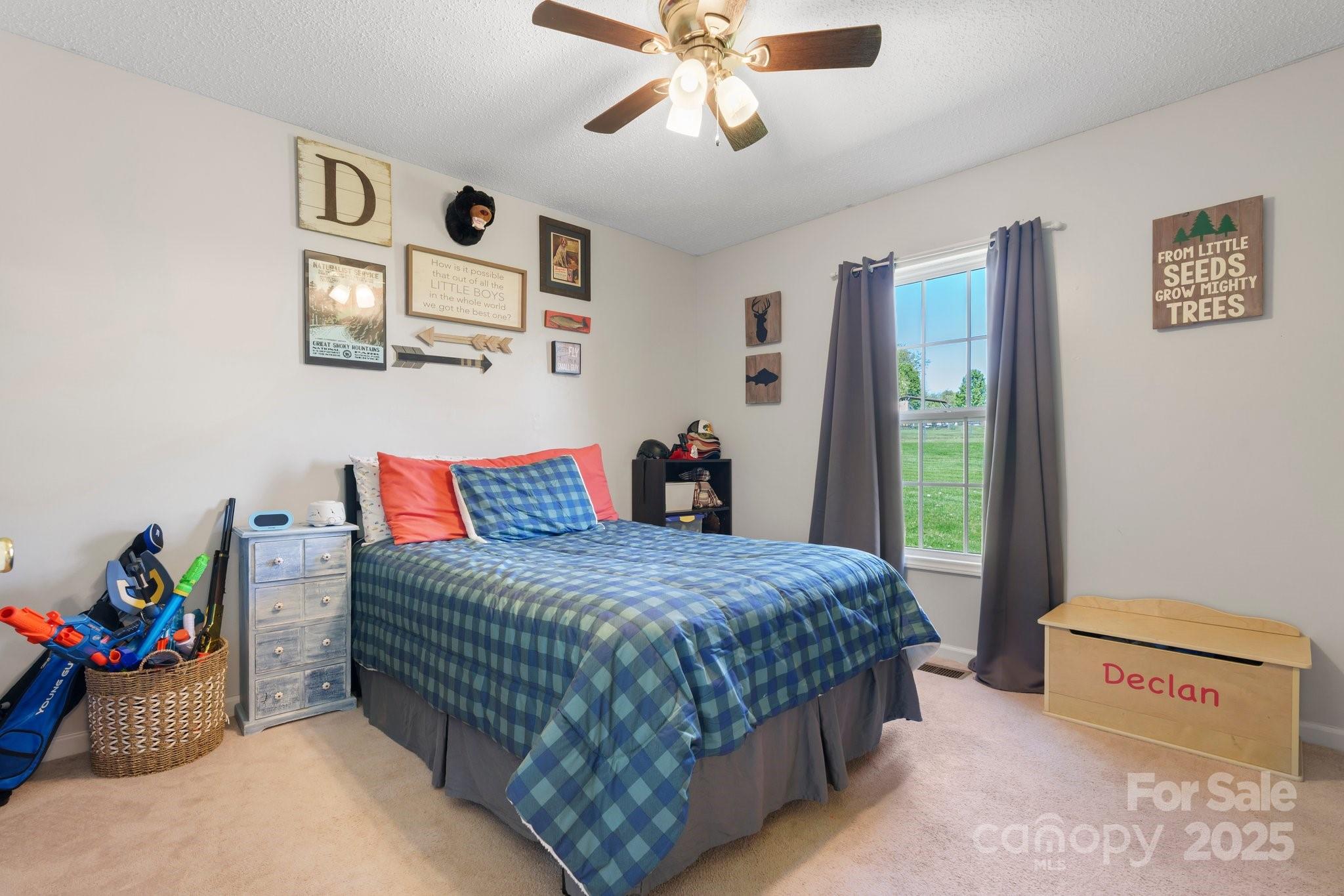 5184 Swinging Bridge Road Conover, NC 28613 - Photo 18 of 38 a bedroom with a bed and a chandelier