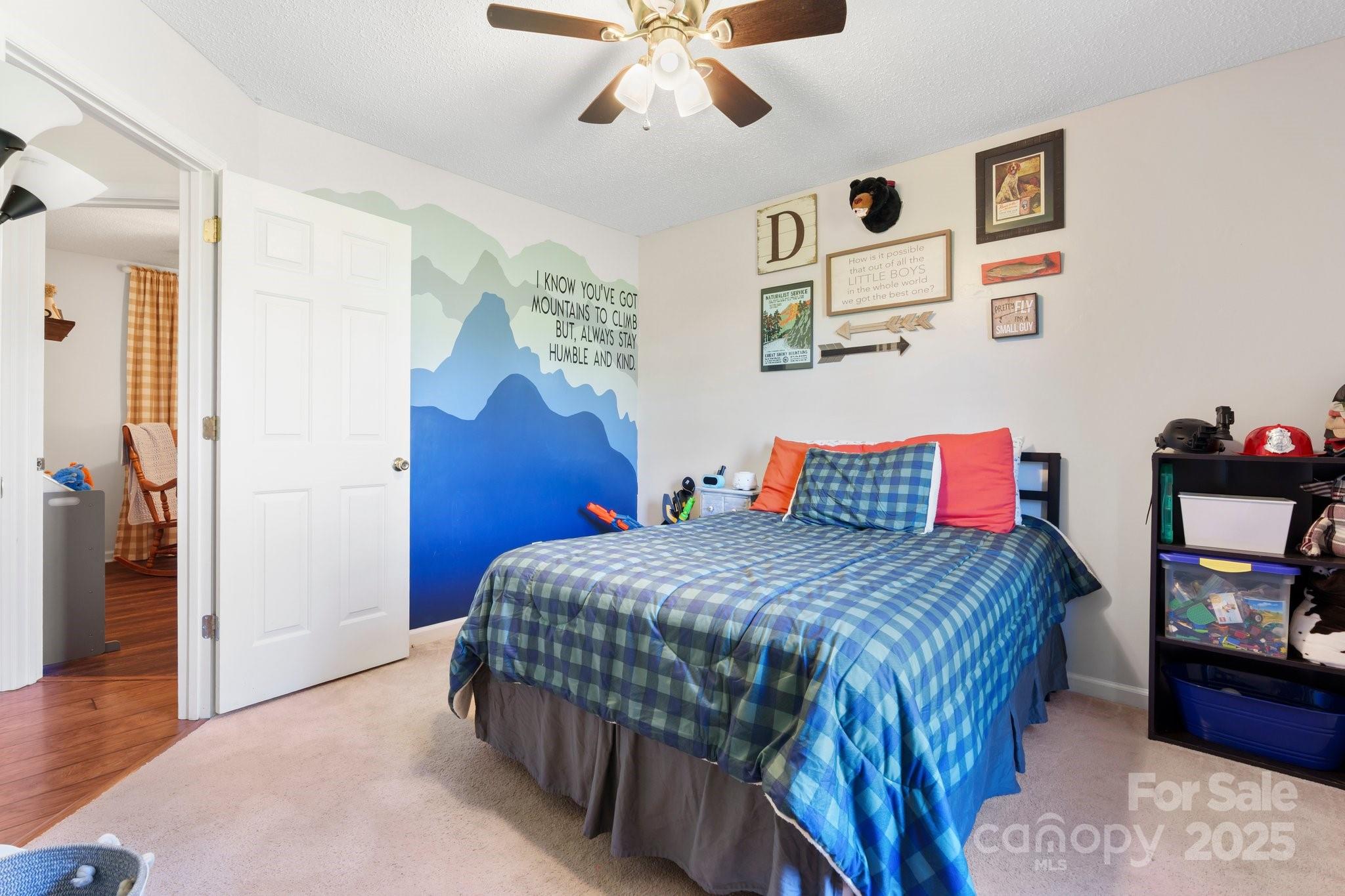 5184 Swinging Bridge Road Conover, NC 28613 - Photo 19 of 38 a bedroom with a bed and dresser with wooden floor