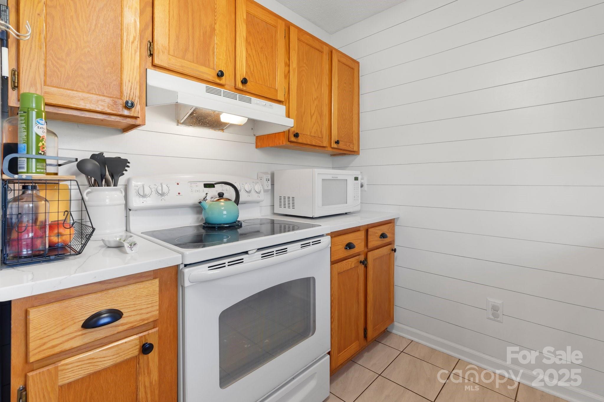 5184 Swinging Bridge Road Conover, NC 28613 - Photo 9 of 38 a kitchen with stainless steel appliances white cabinets and a stove top oven