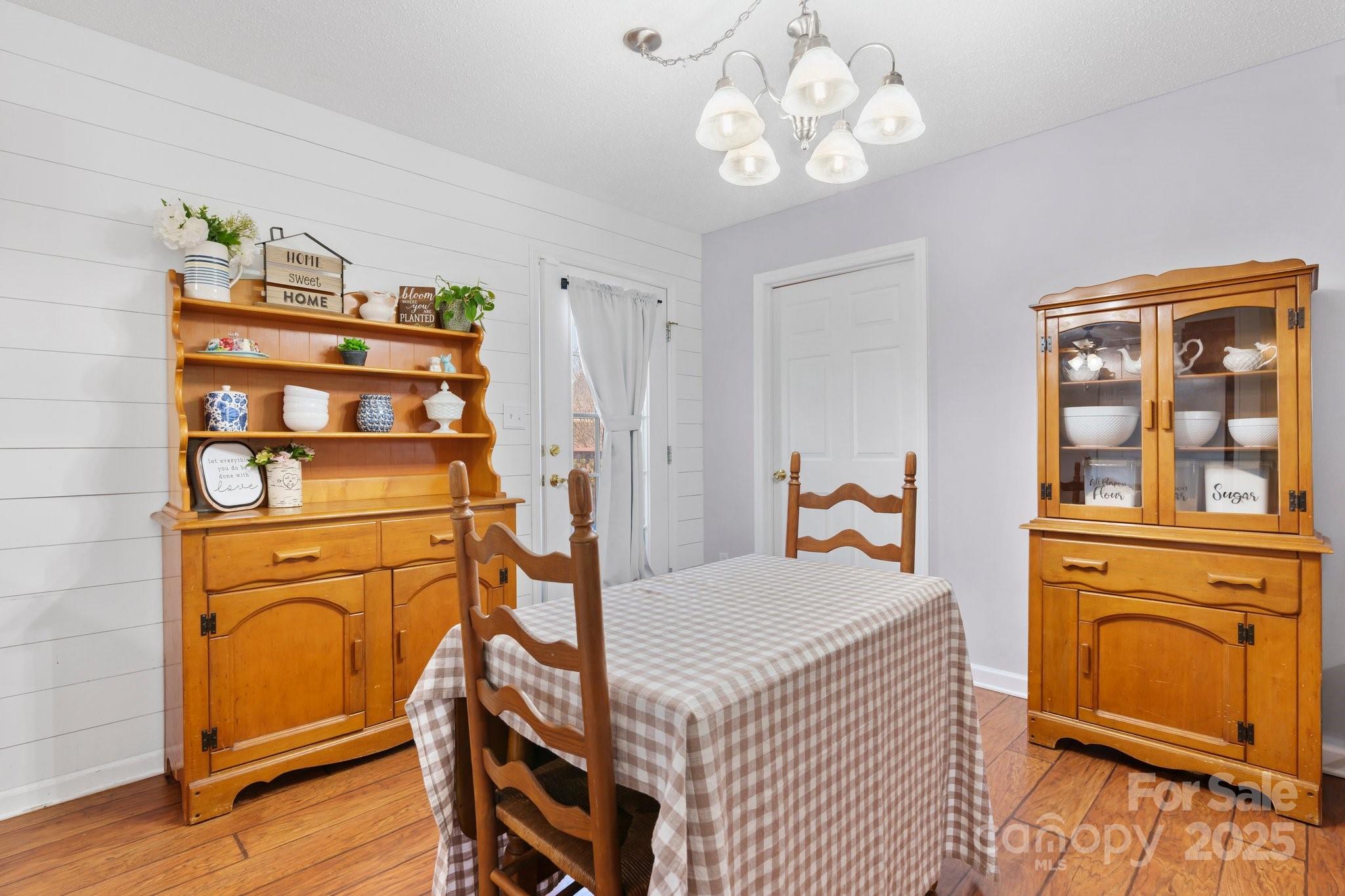 5184 Swinging Bridge Road Conover, NC 28613 - Photo 10 of 38 a bedroom with a bed and a chandelier