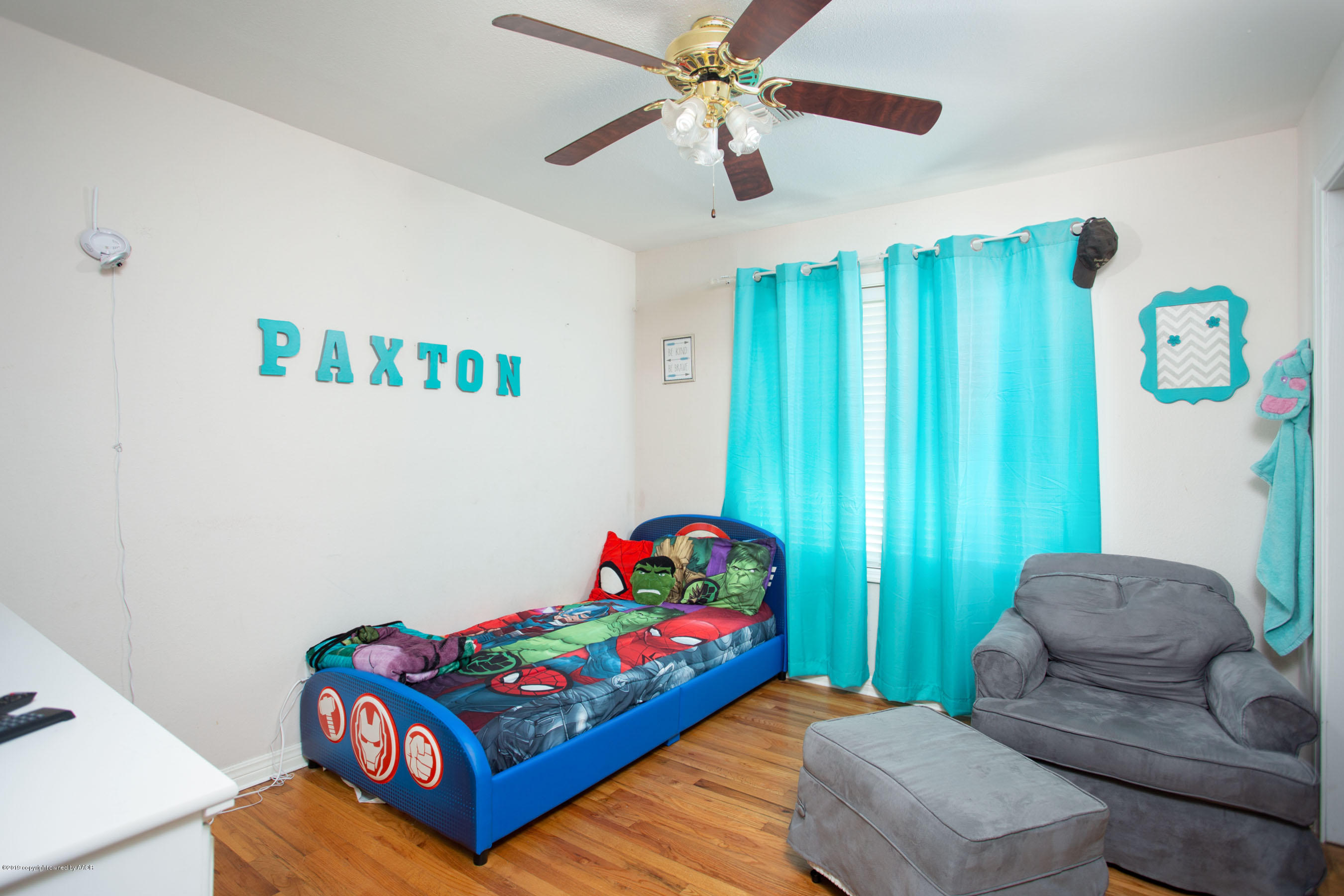 4122 South Travis Street Amarillo, TX 79110 - Photo 11 of 18 a bedroom with a bed and a chandelier