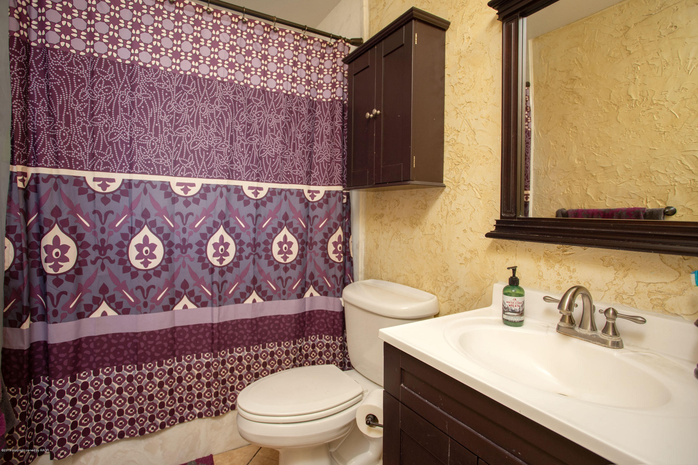 4122 South Travis Street Amarillo, TX 79110 - Photo 13 of 18 a bathroom with a sink and a toilet