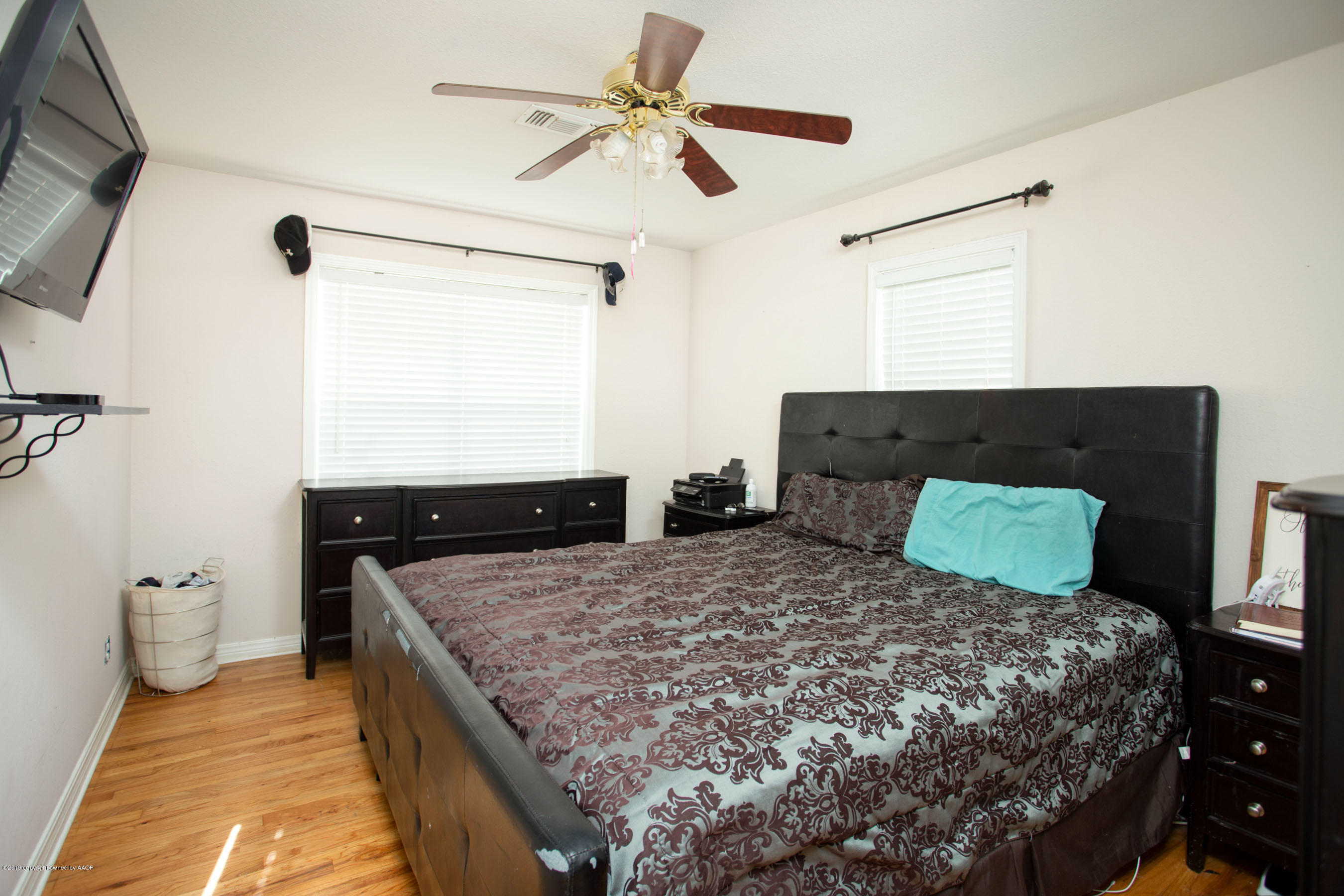 4122 South Travis Street Amarillo, TX 79110 - Photo 15 of 18 a bedroom with a large bed and a flat tv screen on dresser