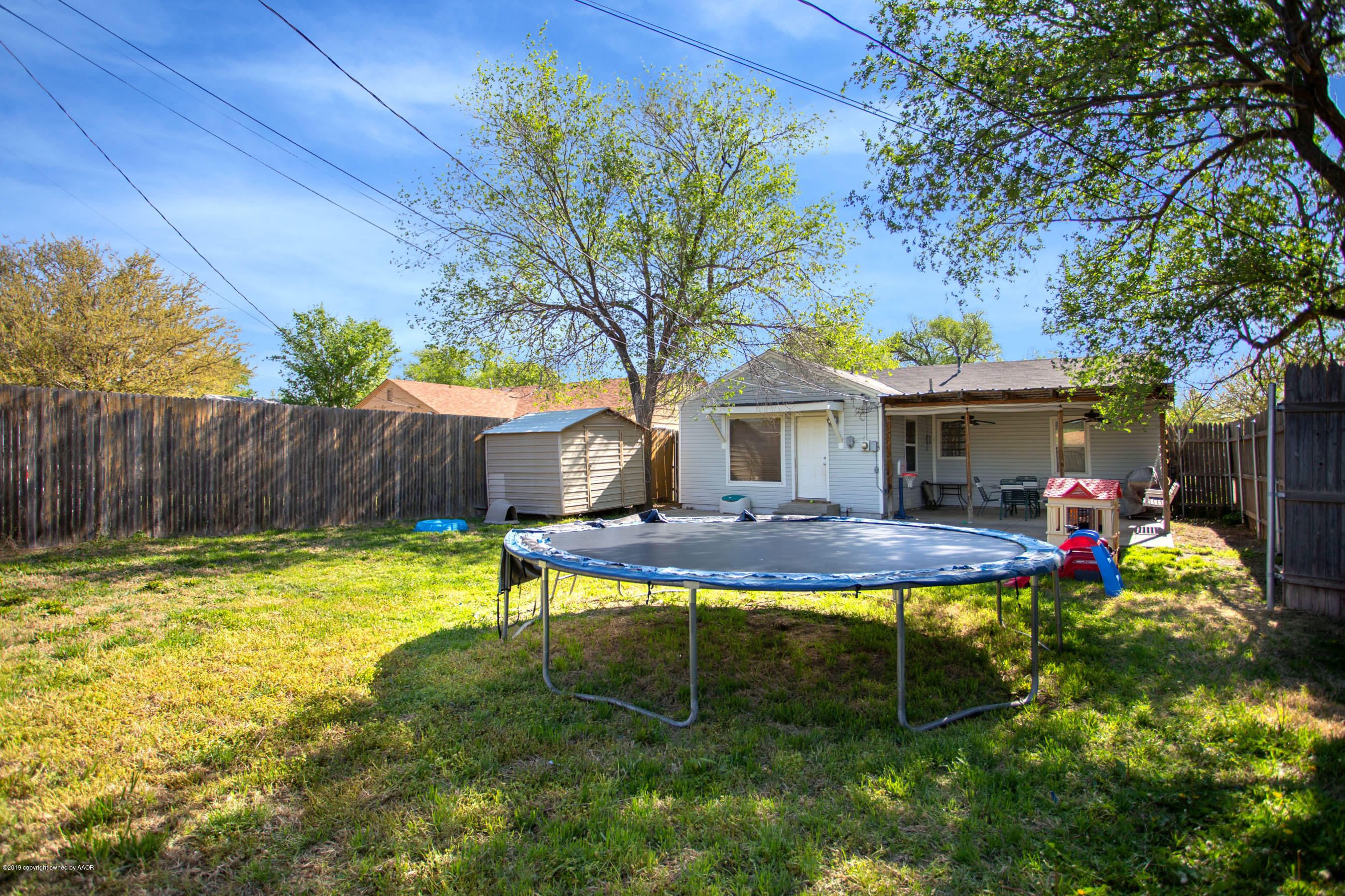 4122 South Travis Street Amarillo, TX 79110 - Photo 18 of 18 a view of a house with backyard and a slide