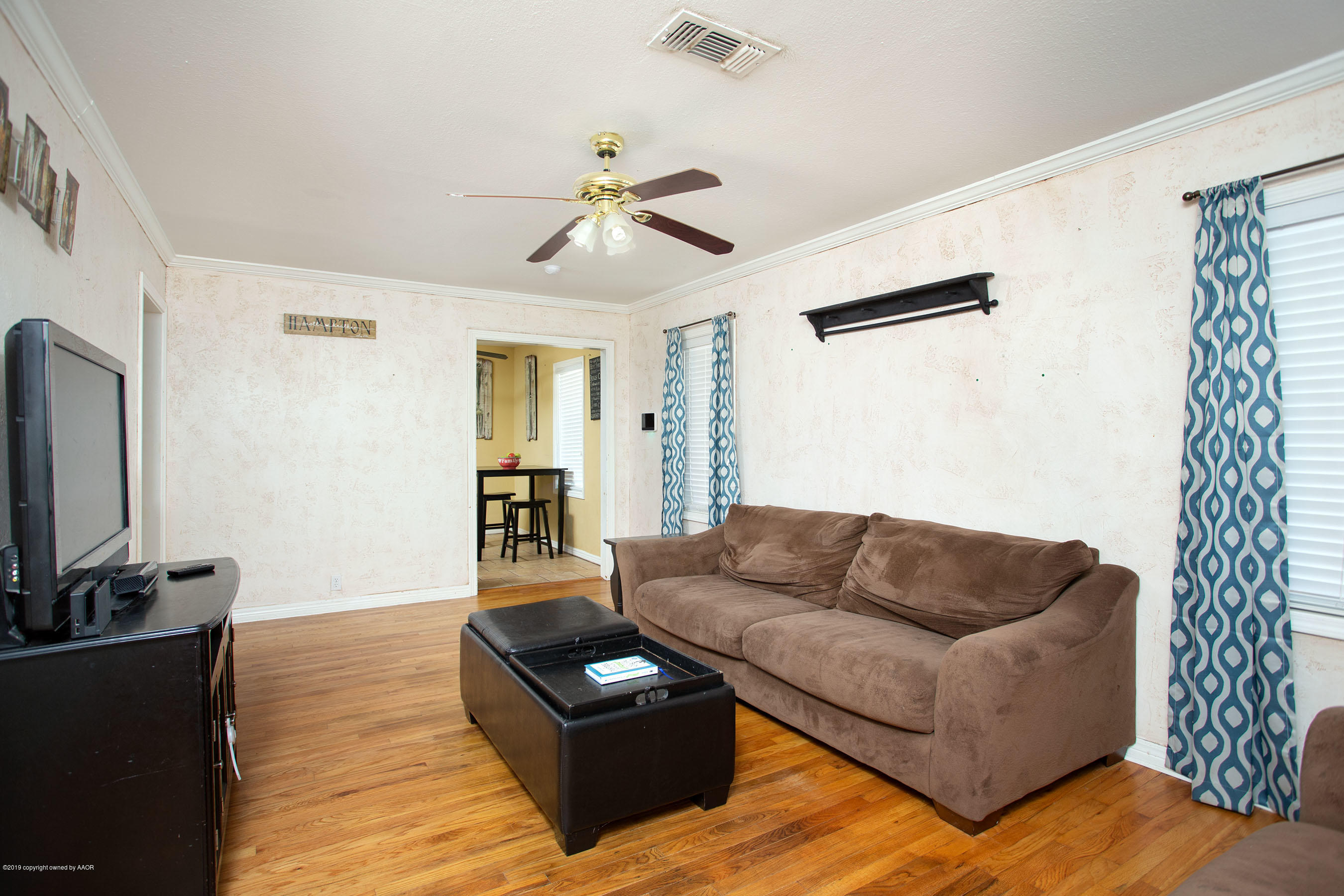 4122 South Travis Street Amarillo, TX 79110 - Photo 3 of 18 a living room with furniture and a flat screen tv