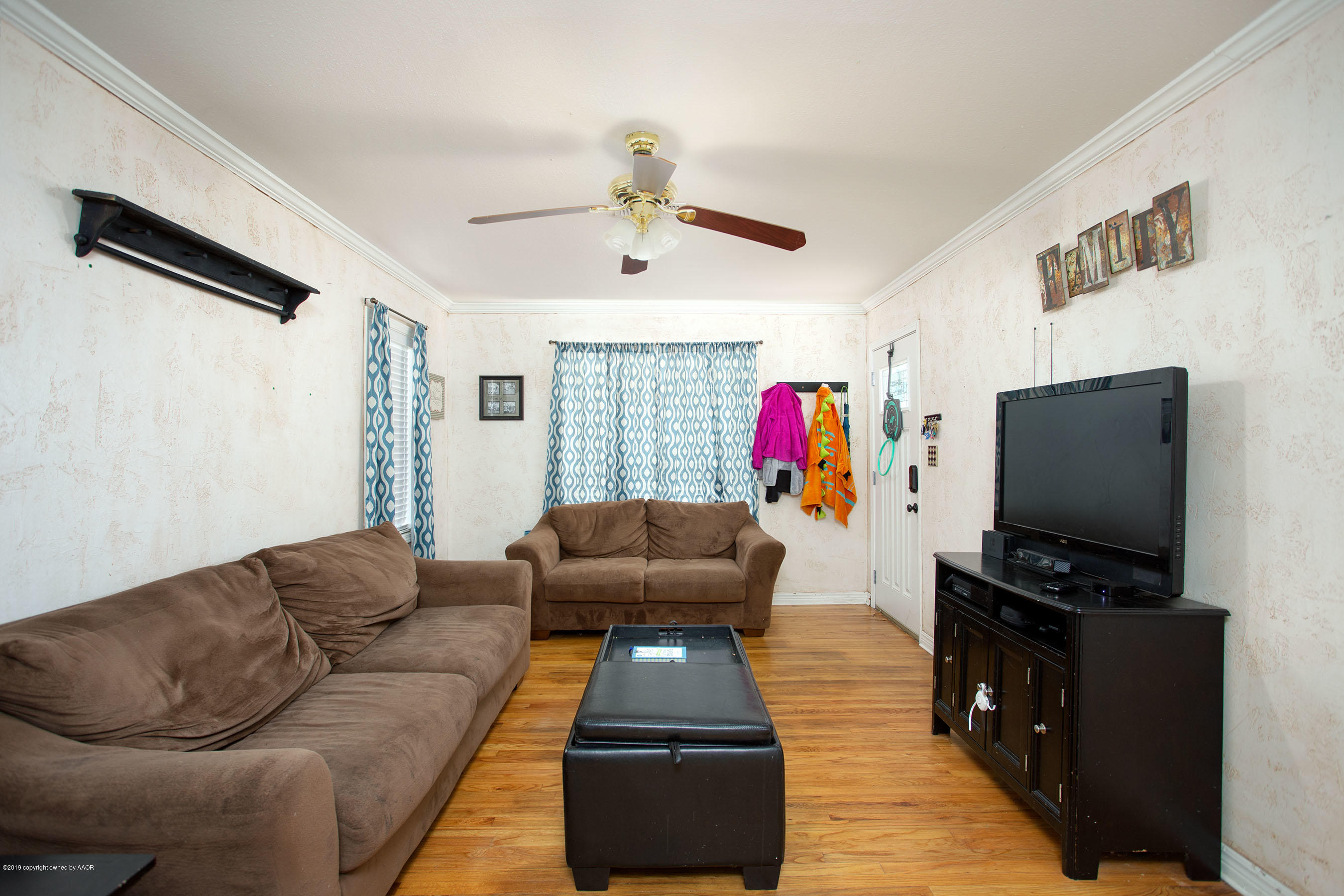 4122 South Travis Street Amarillo, TX 79110 - Photo 4 of 18 a living room with furniture and a flat screen tv