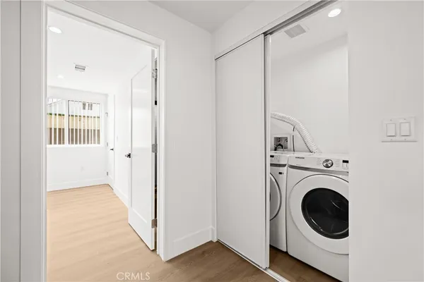 a view of a hallway with washer and dryer