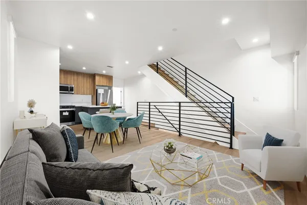 a living room with furniture and kitchen view