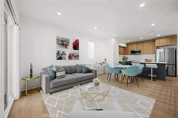 a living room with furniture and kitchen view