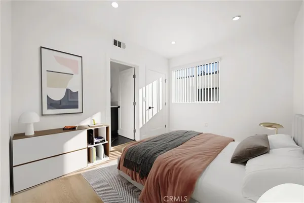 a bedroom with a bed and a painting on the wall