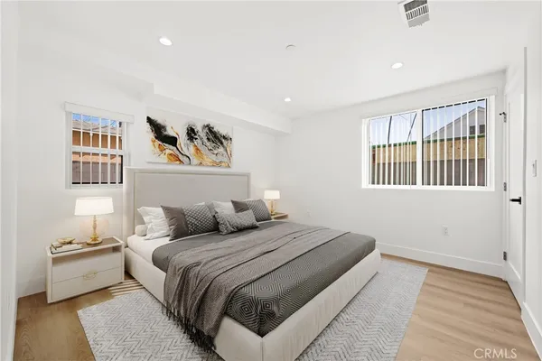 a bedroom with a large bed and a window