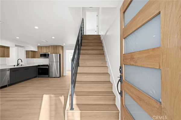 a view of kitchen with sink microwave and refrigerator