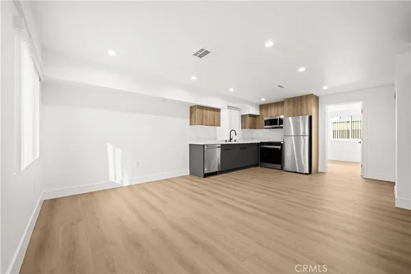 a view of a kitchen with a sink and a stove top oven
