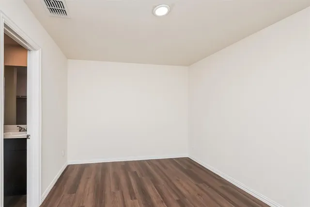 a view of a room with wooden floor