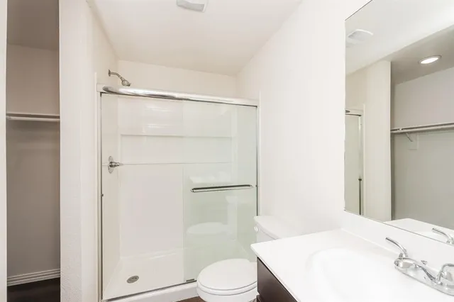 a bathroom with a sink toilet and shower