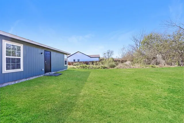 a view of an house with backyard space and garden