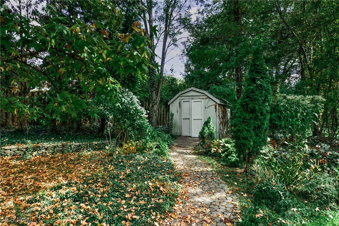 View of yard featuring a storage unit