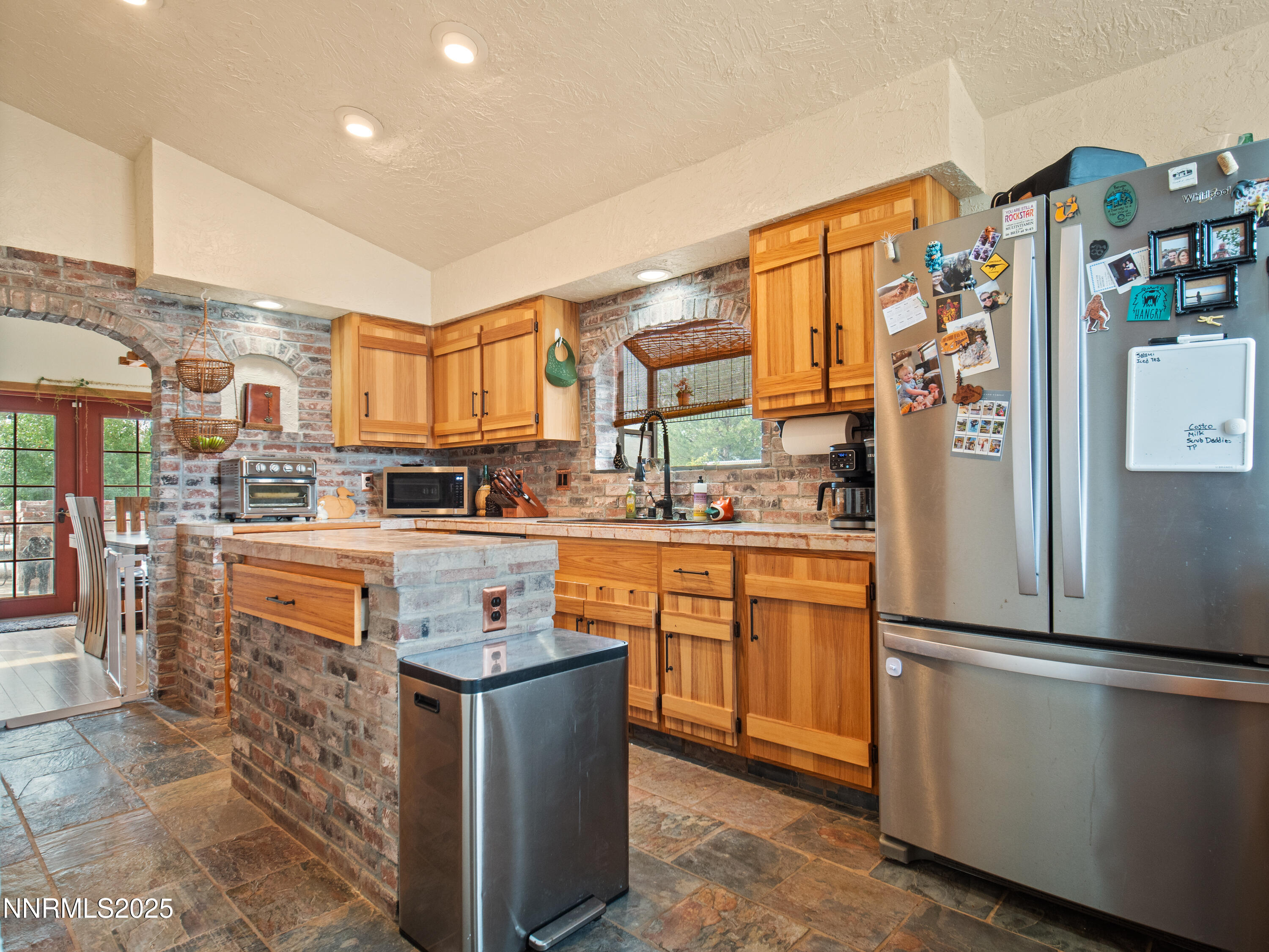 1263 Bronco Circle Minden, NV 89423 - Photo 13 of 33 a kitchen with stainless steel appliances granite countertop a refrigerator a stove and a sink