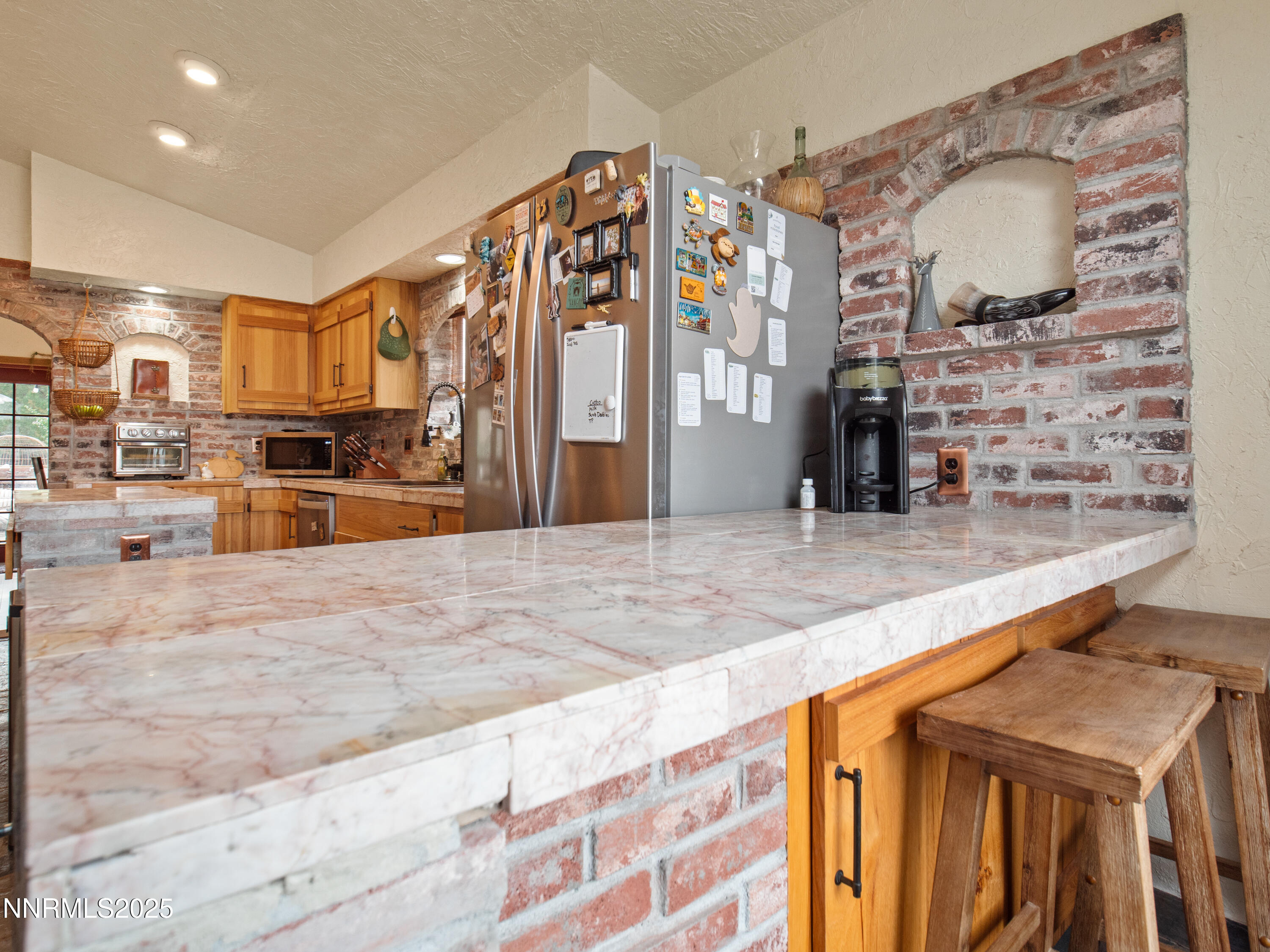 1263 Bronco Circle Minden, NV 89423 - Photo 19 of 33 a large kitchen with stainless steel appliances granite countertop a sink and cabinets