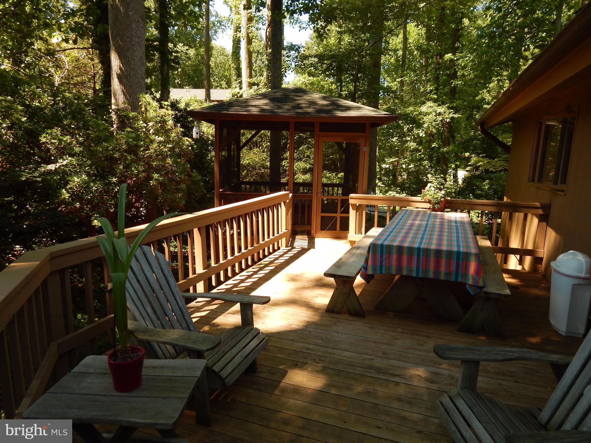 4017 Easterbell Road Port Republic, MD 20676 - Photo 20 of 30 a view of a wooden deck with furniture and a yard