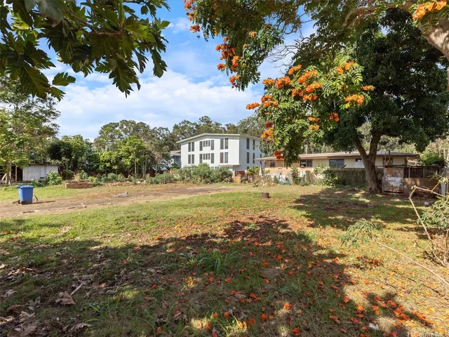a view of yard with swimming pool and trees