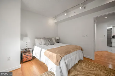 a bedroom with a bed and a mirror