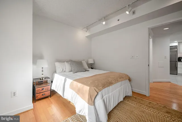 a bedroom with a bed and a mirror