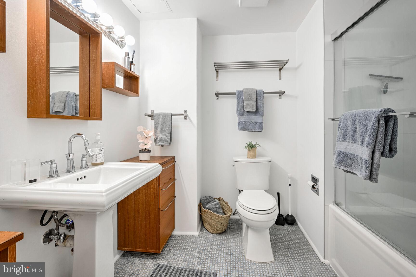 2301 N Street Northwest, Unit 104 Washington, DC 20037 - Photo 17 of 22 a bathroom with a sink toilet and shower