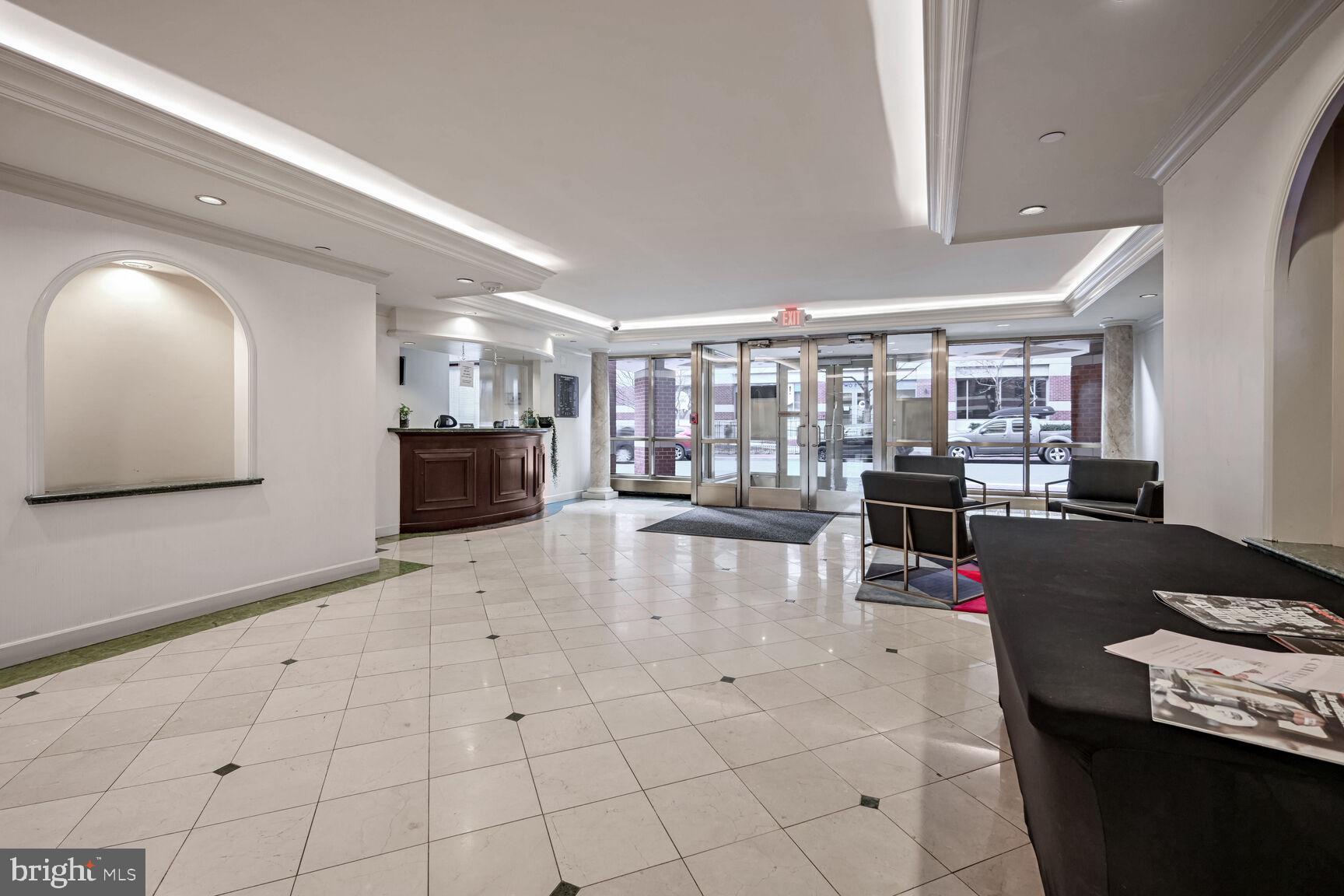2301 N Street Northwest, Unit 104 Washington, DC 20037 - Photo 22 of 22 a lobby with furniture and view of kitchen