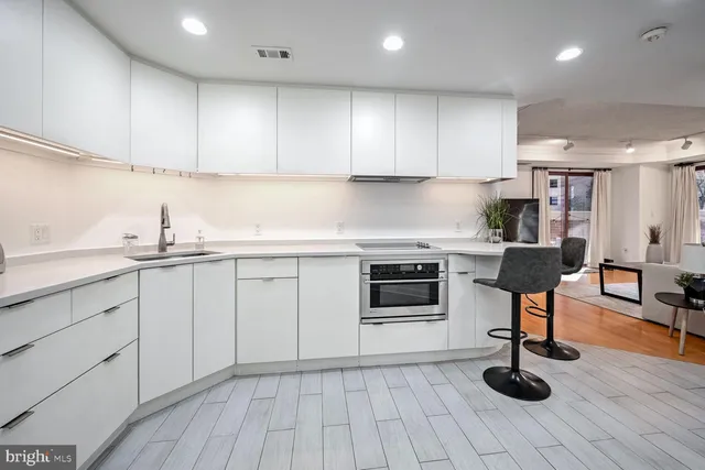 a kitchen with granite countertop a stove a sink and a microwave