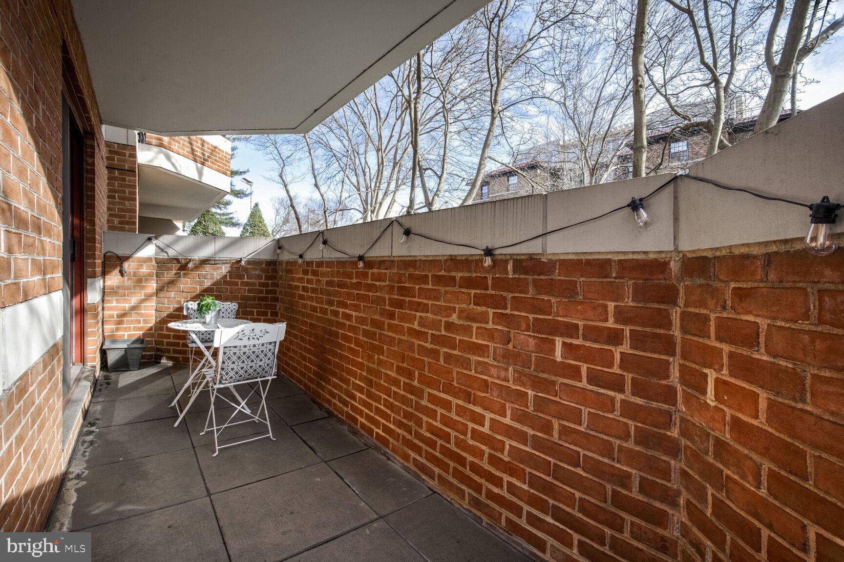 2301 N Street Northwest, Unit 104 Washington, DC 20037 - Photo 10 of 22 a backyard of a house with table and chairs