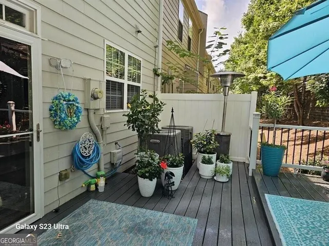 a view of backyard with outdoor seating and plants