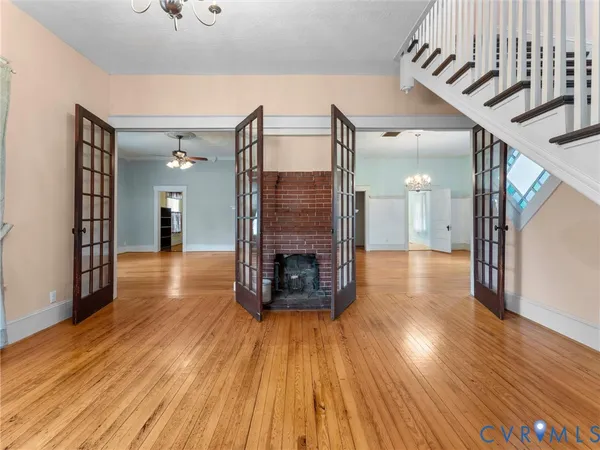 a view of a hallway with wooden floor and a fireplace