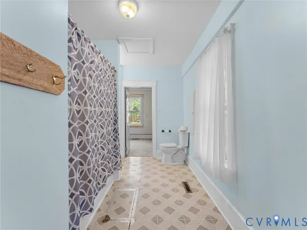 a bathroom with a shower and a toilet