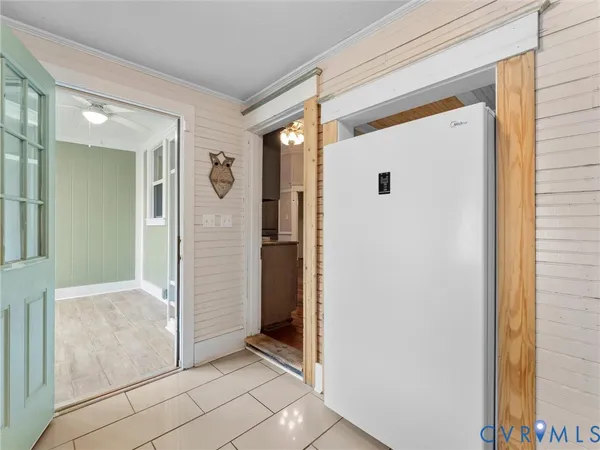 a view of hallway with livingroom and wooden floor