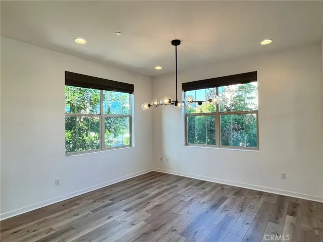 a view of an empty room with wooden floor outdoor and a window