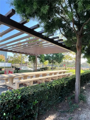 a view of yard with a table and chairs under an umbrella