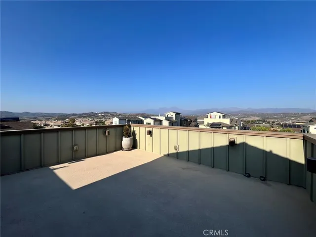 a view of a balcony with two chairs and a table