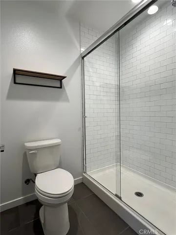 a bathroom with a toilet and a shower